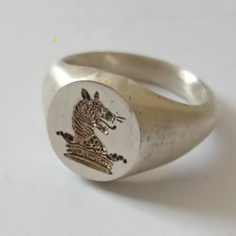 Crest engraved silver signet ring prior to finishing and polishing